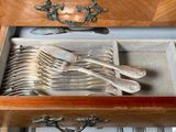 a drawer with silverware in it and a drawer with silverware in it