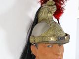 a statue of a man in a military uniform with a red feather on his head