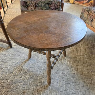 a small table with a wooden top in a living room