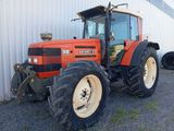 a tractor that is parked in front of a building