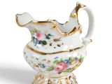 an image of a white and gold vase with flowers on it