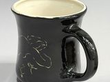 a black and white coffee mug with a horse design on it