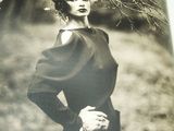 a black and white photo of a woman wearing a wreath of branches