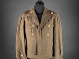 a brown jacket on a mannequin stand with a black background