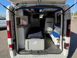 a small van with a bed in the back of it