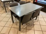 tables and chairs in a restaurant with a window in the background