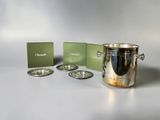 a silver ice bucket sitting next to a green box