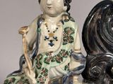 a figurine of a man sitting on top of a table