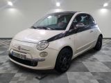 a picture of a small white car parked in a garage