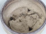 a close up of a bowl with a lot of dirt on it