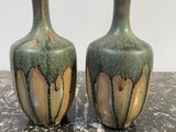 two vases that are sitting on a table