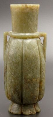 an image of a green vase sitting on top of a table