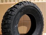 a tire that is sitting on the ground next to a cardboard box