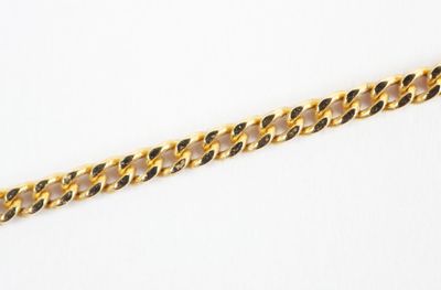 a close up of a gold chain on a white surface