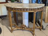 a marble topped table with a vase on top of it