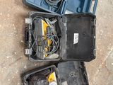 a couple of tools are sitting in a case on the ground