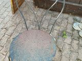 a metal chair that is sitting on the ground