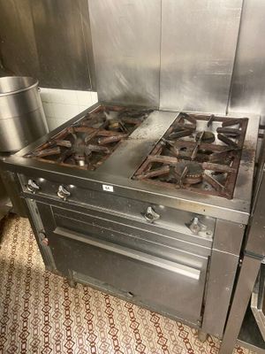 a stove with a pot on top of it in a kitchen