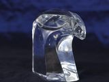 a clear glass animal figurine sitting on a black surface