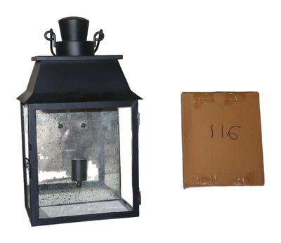 a small black lantern with a price tag on it