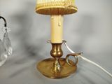 a lamp that is sitting on a table next to a glass vase