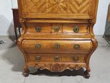 an old wooden chest of drawers with a drawer on top of it
