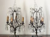 two small crystal chandeliers on a marble table