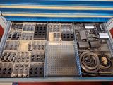 a drawer full of assorted metal parts in a room