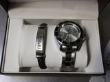 a watch and a bracelet in a box on a table