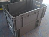 two plastic containers sitting on the floor next to each other