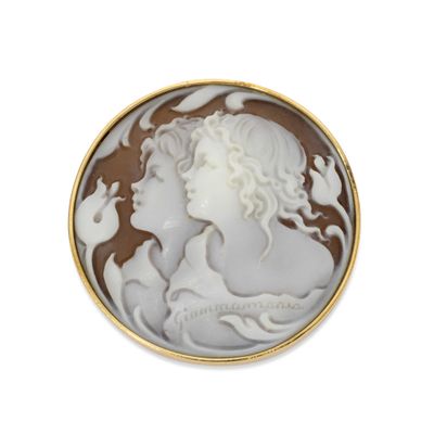an image of a woman ' s face in a shell broochle