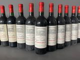 six bottles of red wine lined up in a row on a table