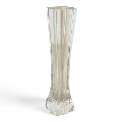 a glass vase that is sitting on a white surface