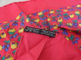 a close up of a red shirt with blue and yellow flowers on it