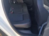 a small car with the door open on the side of the road