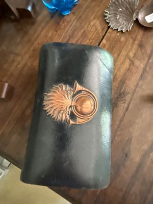 a black leather case with a picture of a bird on it