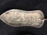 a silver spoon with a flower design on it