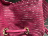 purple purse with a pink handle and two gold rings