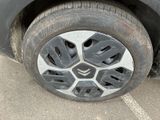 a close up of a tire on a car in a parking lot