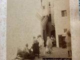 an old photo of a group of people standing in front of a building