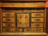 a large wooden cabinet with many drawers and doors
