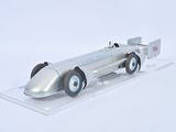 a silver model of a race car on a clear surface