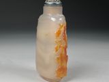a picture of a glass bottle with an orange lid