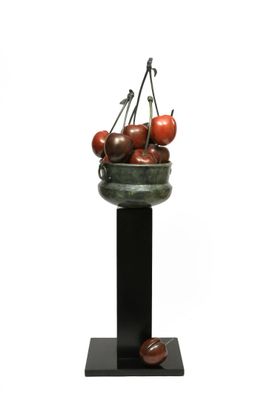 an image of a sculpture of a basket of tomatoes on a pedestal