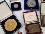 a lot of gold and silver medals in a case