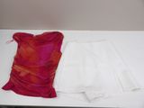 a white skirt and a red top on a white table