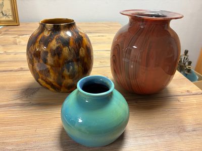 three vases sitting on a table next to each other