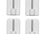 four white plastic wall hooks with a metal bar on each side