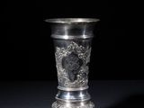 an antique silver cup on a black background with a black background