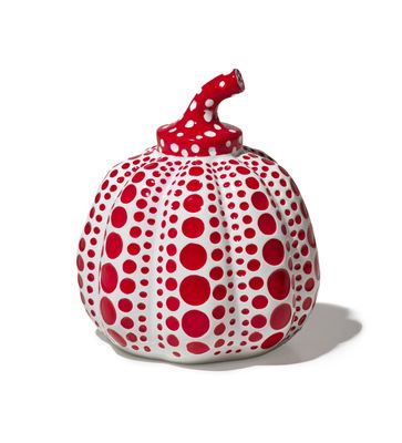 a red and white polka dot pumpkin with a red bow on top